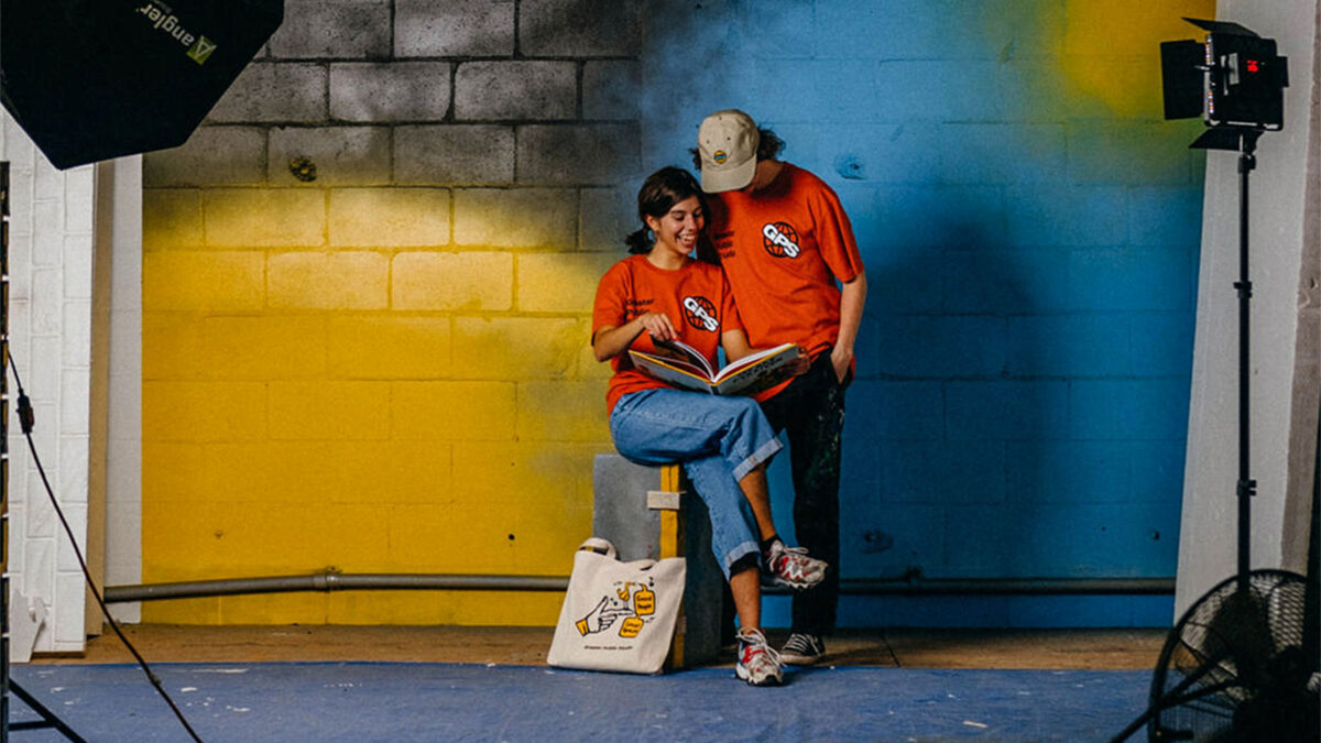 Julia and Blake against a backdrop with the Greater Public Studio Spring Collection Drop